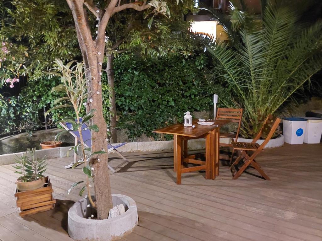 a wooden table and chair next to a tree at Albamare in Monterosso al Mare