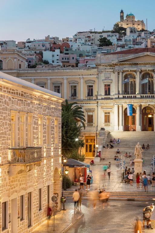 a group of people walking in front of a building at SYROS SOUL LUXURY SUITES in Ermoupoli