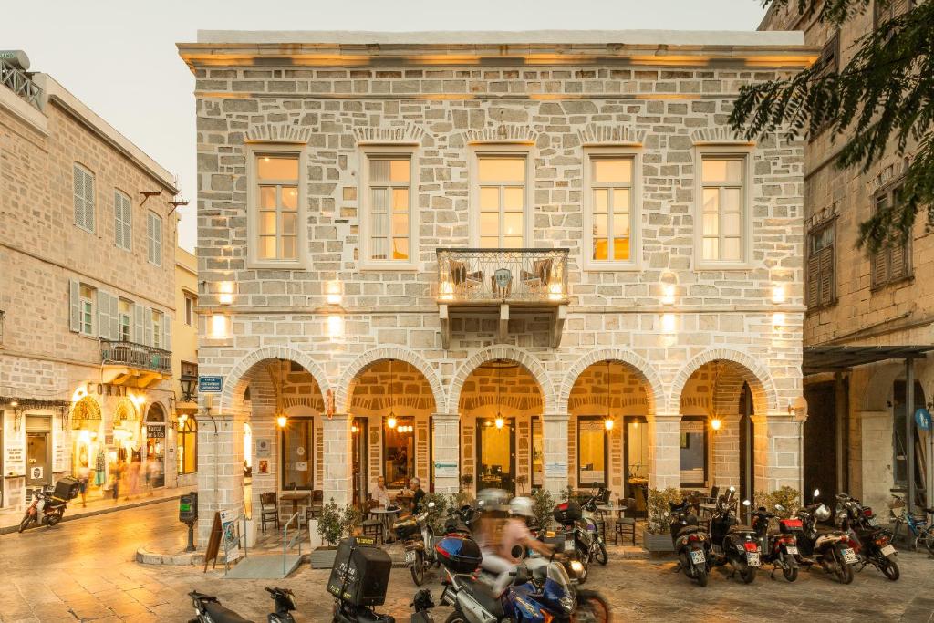 a building with motorcycles parked in front of it at SYROS SOUL LUXURY SUITES in Ermoupoli