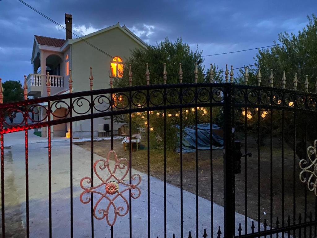 a gate in front of a house with christmas lights at Villa Zoe Privlaka-Zadar in Privlaka