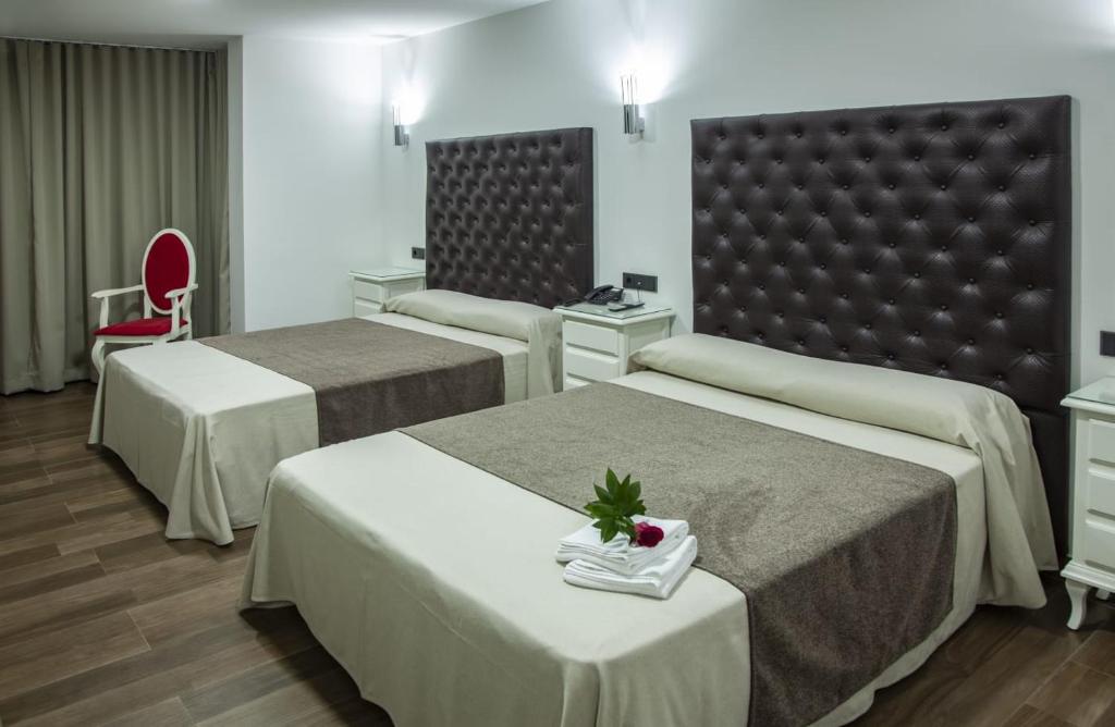 Postel nebo postele na pokoji v ubytování Hotel Julián