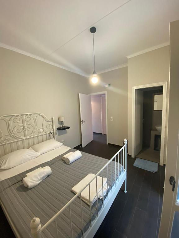a bedroom with a large bed with two pillows at AEGEAN VIEW SEASIDE ROOMS AND STUDIOS KEA in Korissia