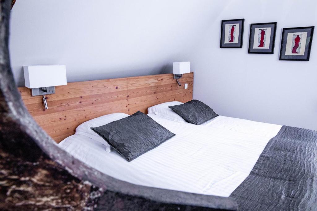 a bedroom with a bed with two pillows on it at App'Art - Le A in Kaysersberg