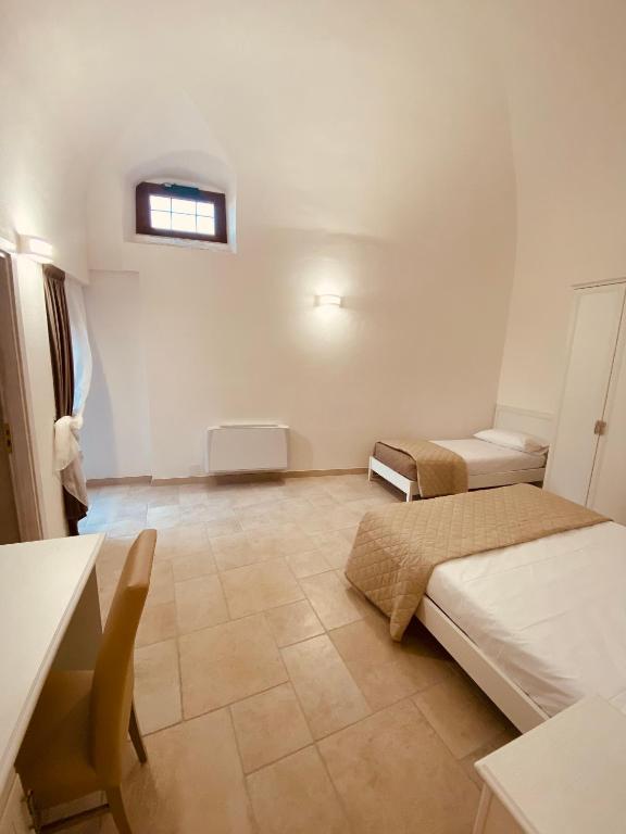 A bed or beds in a room at RELAIS SAN MARCO LUXURY GUEST HOUSE