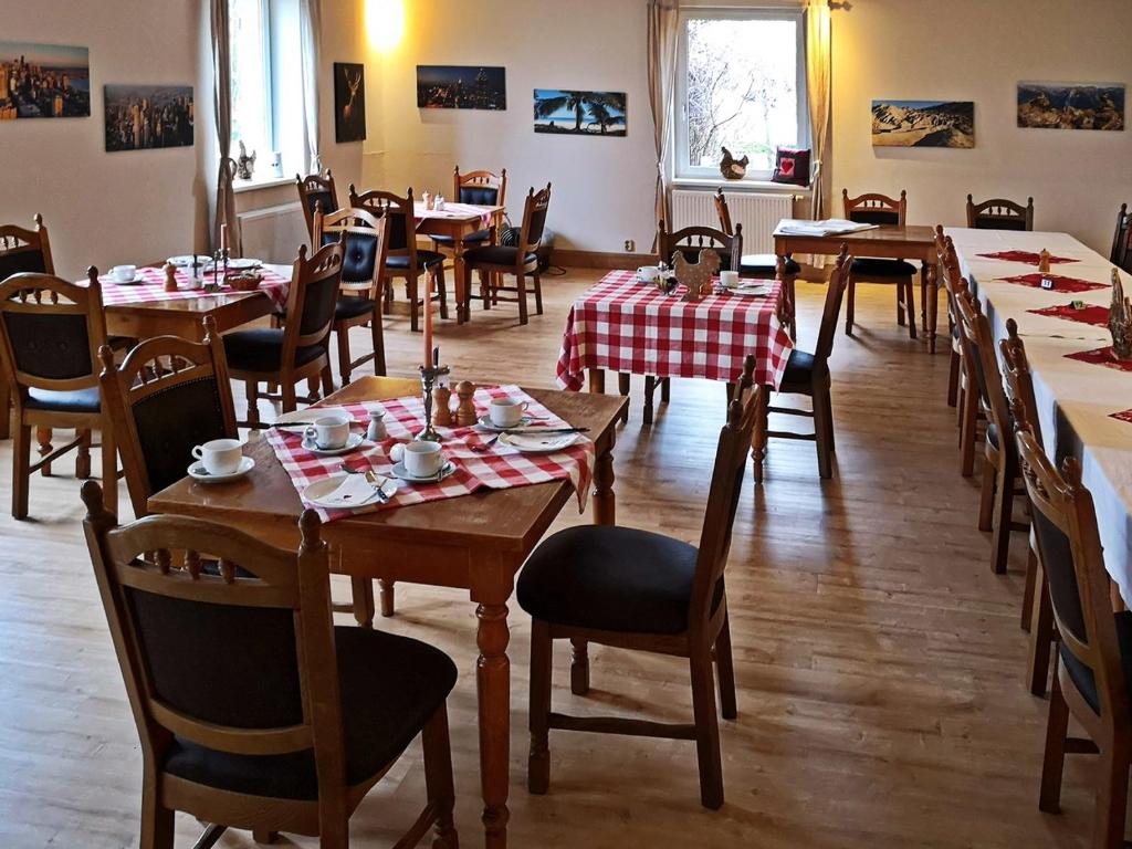 a dining room with wooden tables and chairs at Landlust Hotel in Gransee