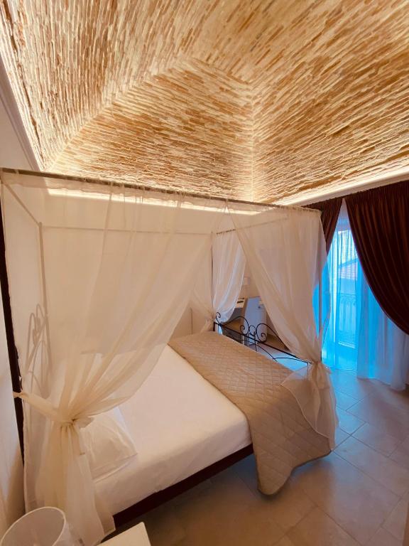 A bed or beds in a room at RELAIS SAN MARCO LUXURY GUEST HOUSE