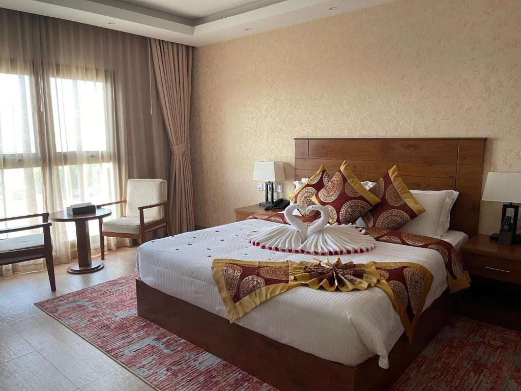 a bedroom with a large bed in a room at Alsahwa Hotel in Seeb