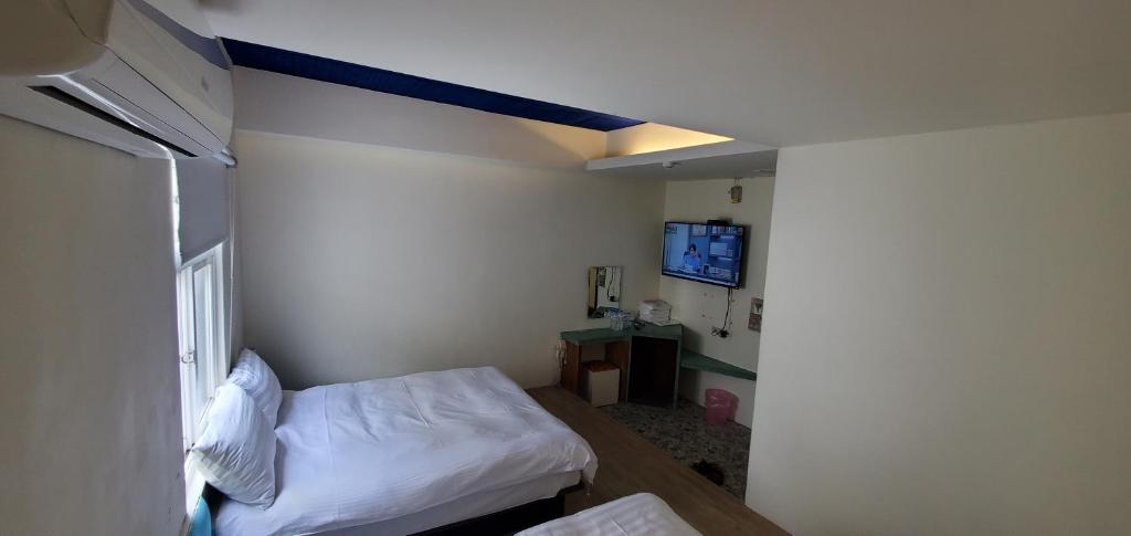 Postel nebo postele na pokoji v ubytování Nandu Inn