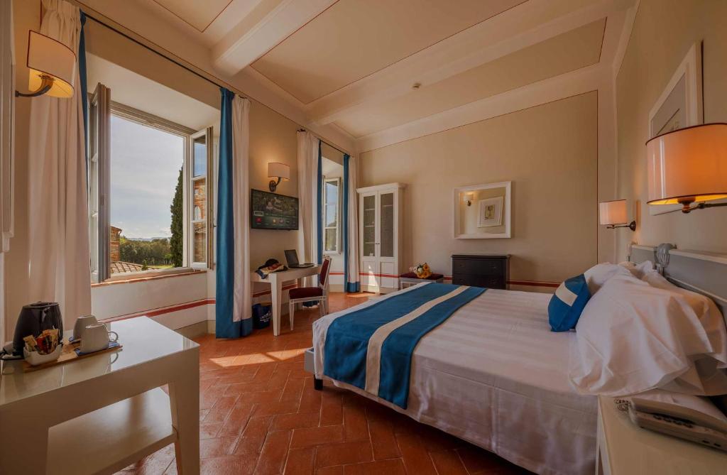 A bed or beds in a room at Borgo Scopeto Wine & Country Relais