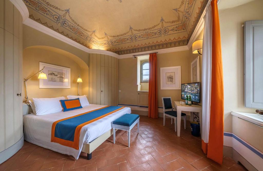 A bed or beds in a room at Borgo Scopeto Wine & Country Relais