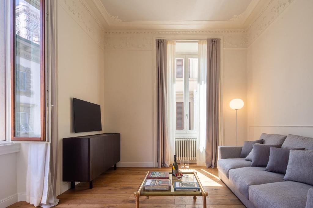 a living room with a couch and a coffee table at Florence Luxury Apartment al Duomo by Mmega in Florence