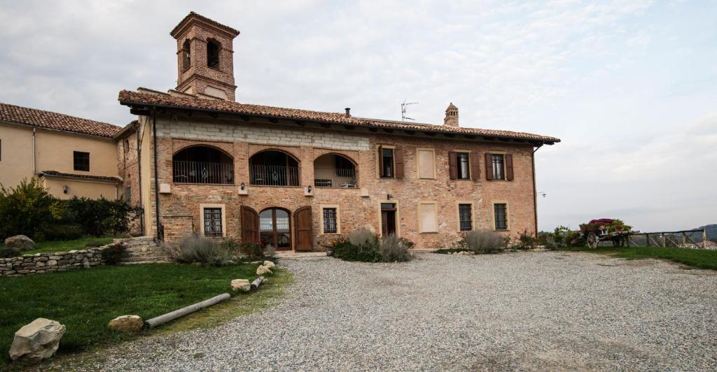 an old stone building with a clock tower on top at La Ca Veja in Murisengo