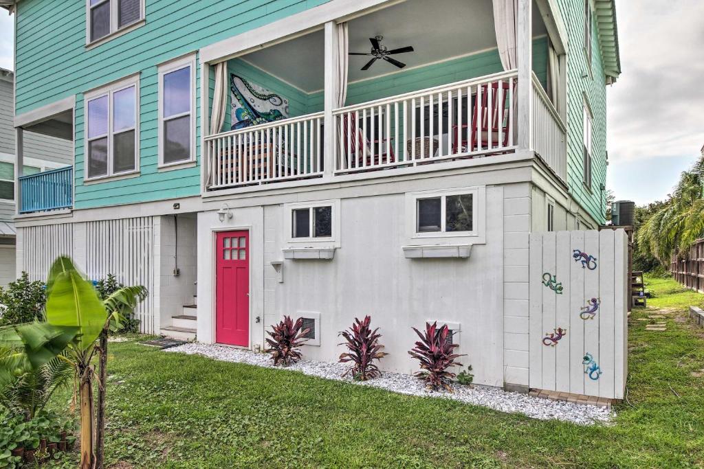 a house with a red door and a balcony at Bright Tybee Island Townhome - Walk to the Beach! in Tybee Island