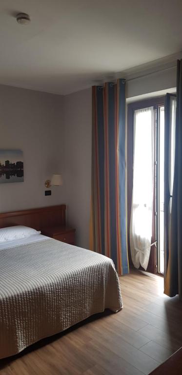 Cama o camas de una habitación en Hotel Alpi Resort