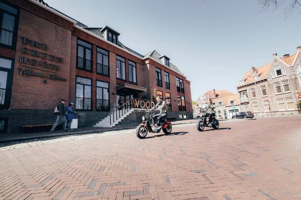 motorcycles are parked in front of a building at Cityhotel Wood in Middelburg