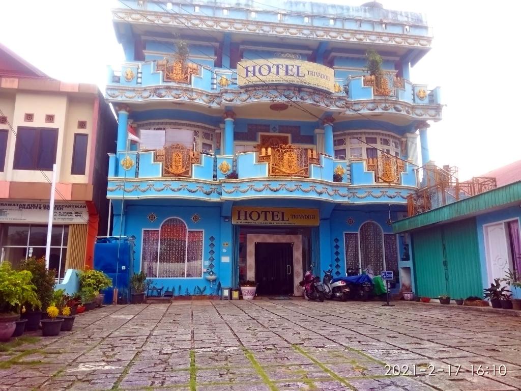 a blue building with a balcony on the front at Trivadoh Syariah Hotel in Padangpanjang