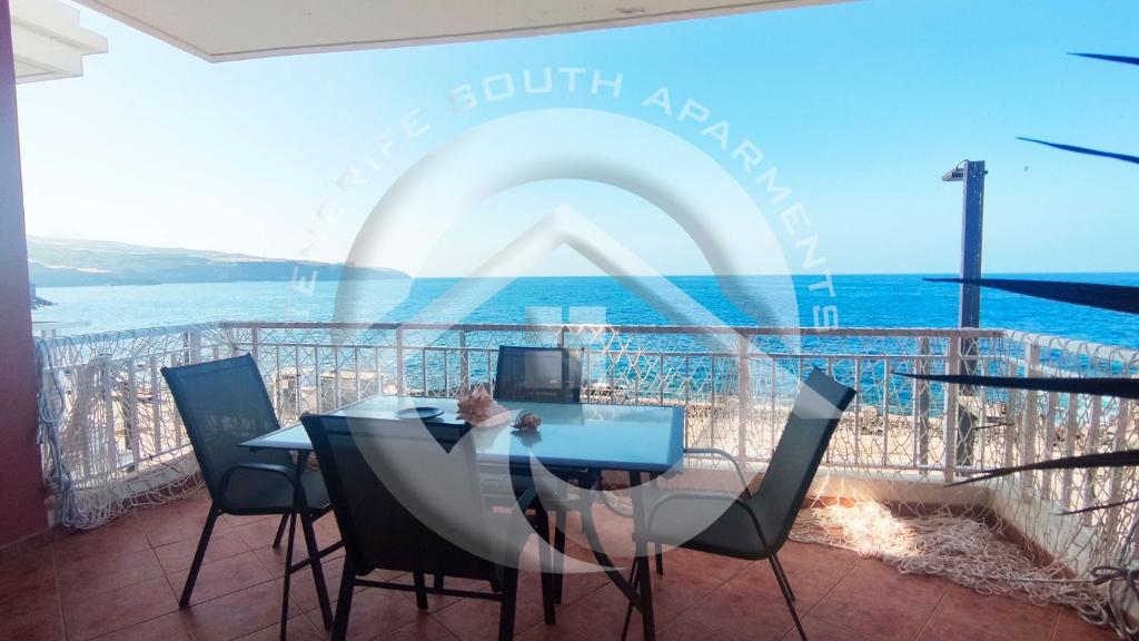 a dining room with a table and chairs and the ocean at My Ocean View in Playa de San Juan