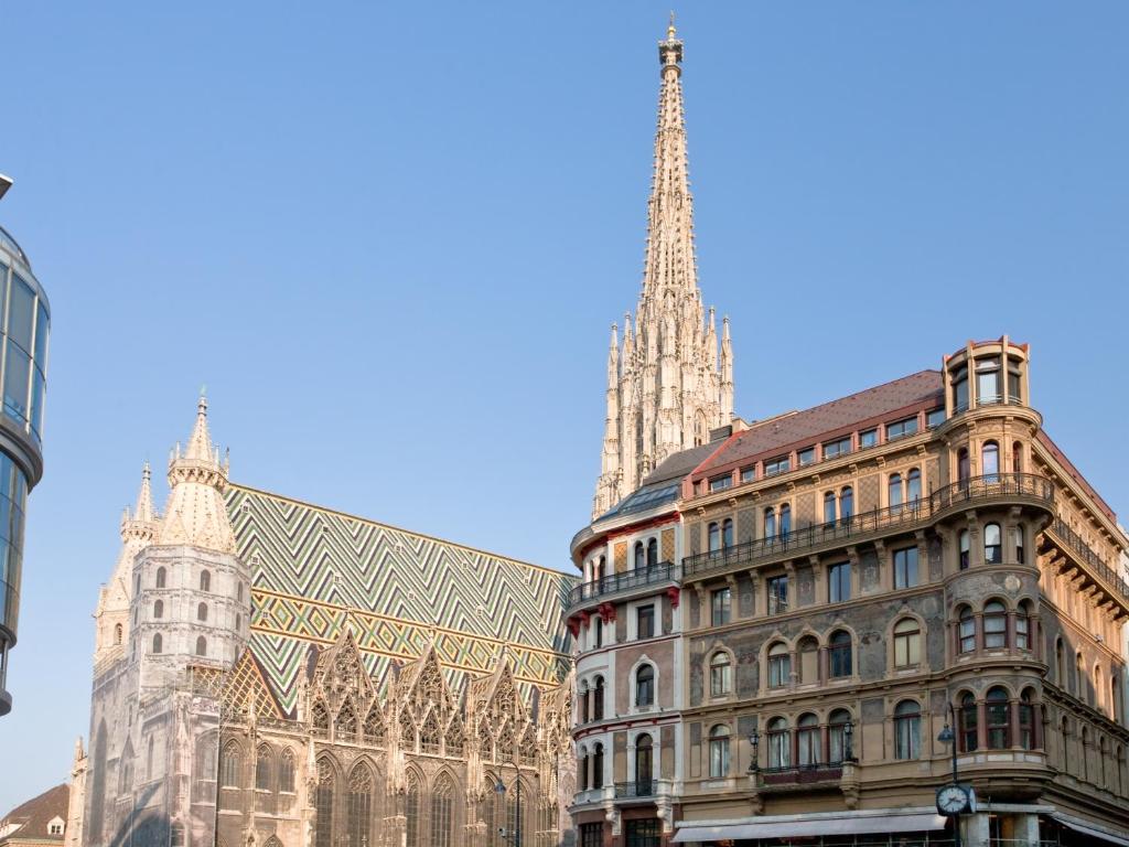 a cathedral and a building with a steeple at Private Comfort STEPHANSPLATZ - SELF CHECK IN in Vienna