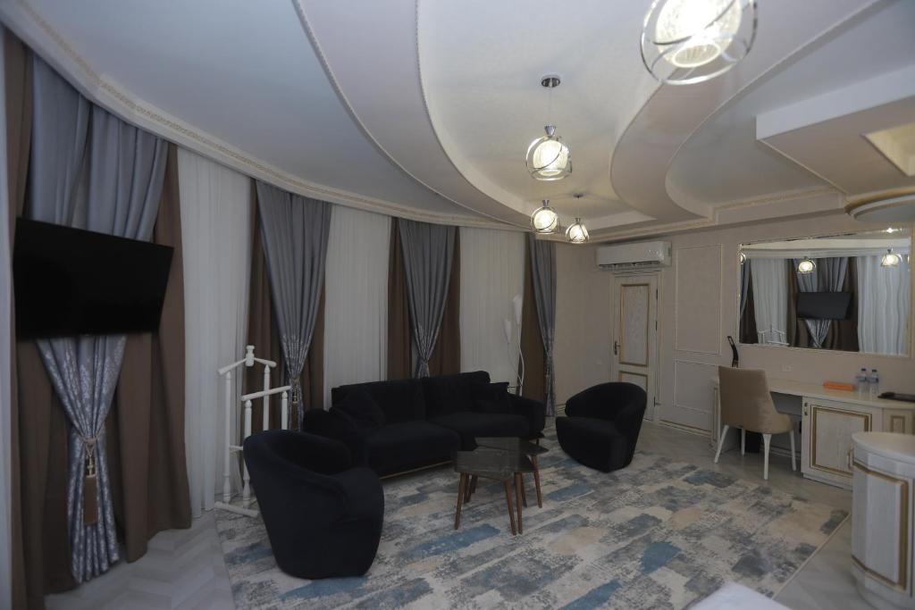 a living room with a couch and chairs and a mirror at Reikartz Amirun Tashkent in Tashkent