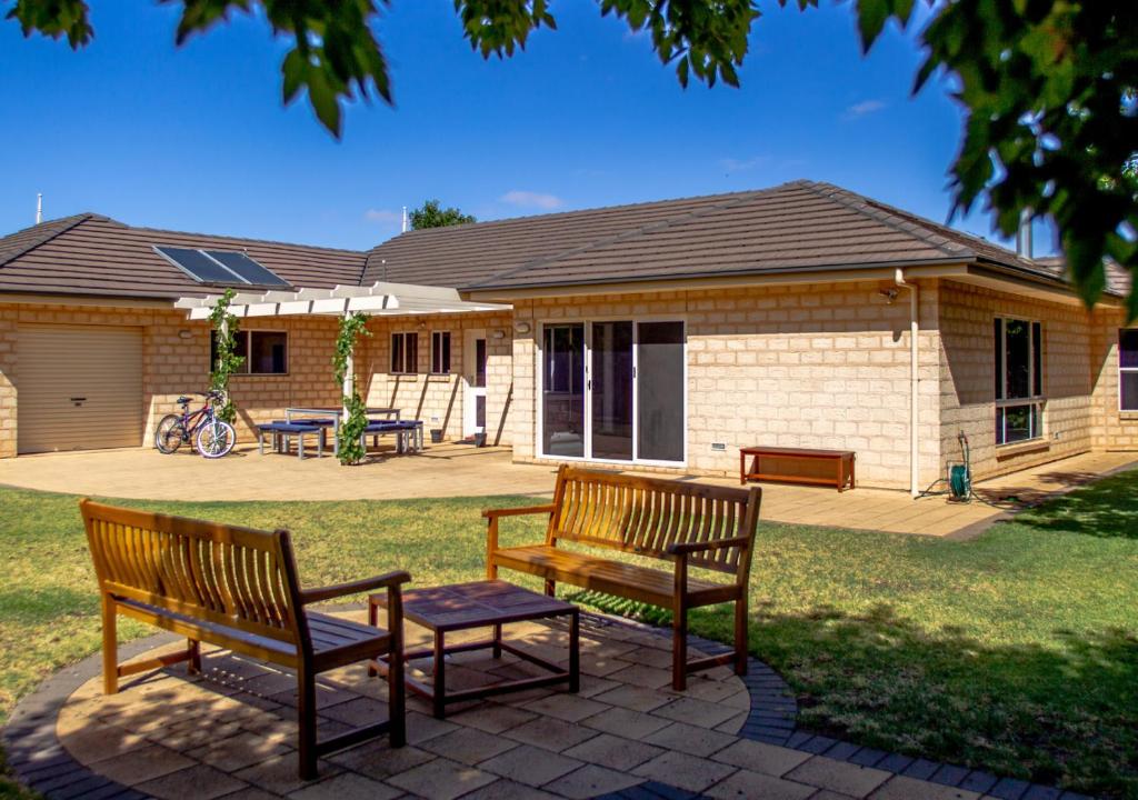 two benches sitting in front of a house at Lochnagar Barossa in Tanunda