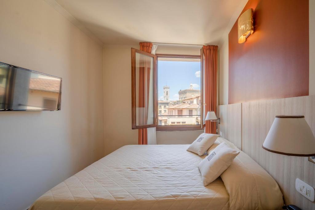 Postel nebo postele na pokoji v ubytování Hotel della Signoria