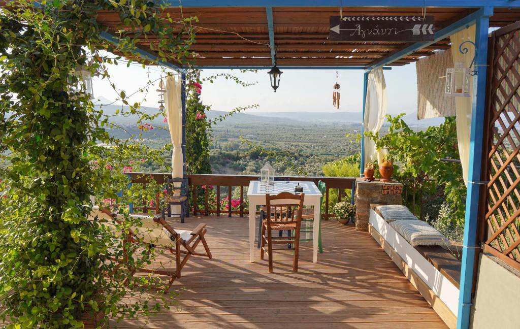 a patio with a table and chairs on a building at Agnanti in Tragána