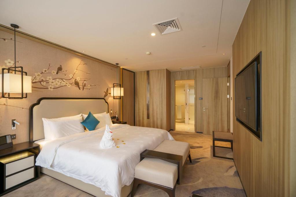 Postel nebo postele na pokoji v ubytování Guangzhou Baiyun Hotel
