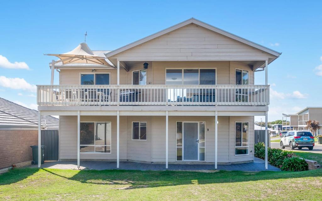 a large house with a balcony on top of it at Rocks Beach House Victor Harbor in Hayborough