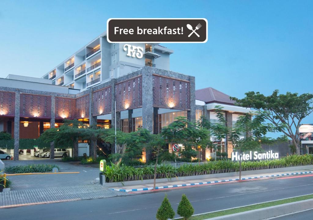 a building with a street sign in front of it at Hotel Santika Banyuwangi in Banyuwangi