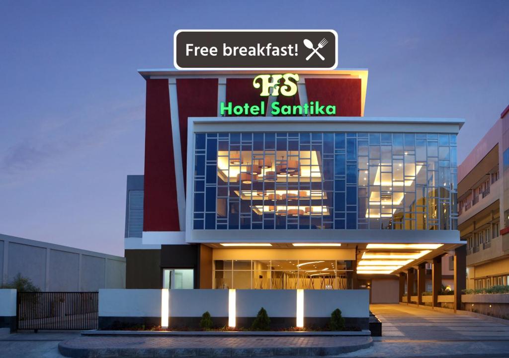 a building with a hotel sign on top of it at Hotel Santika Bengkulu in Bengkulu