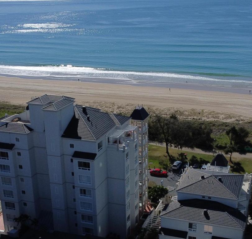 a beach with a large building on top of it at La Grande Apartments in Gold Coast