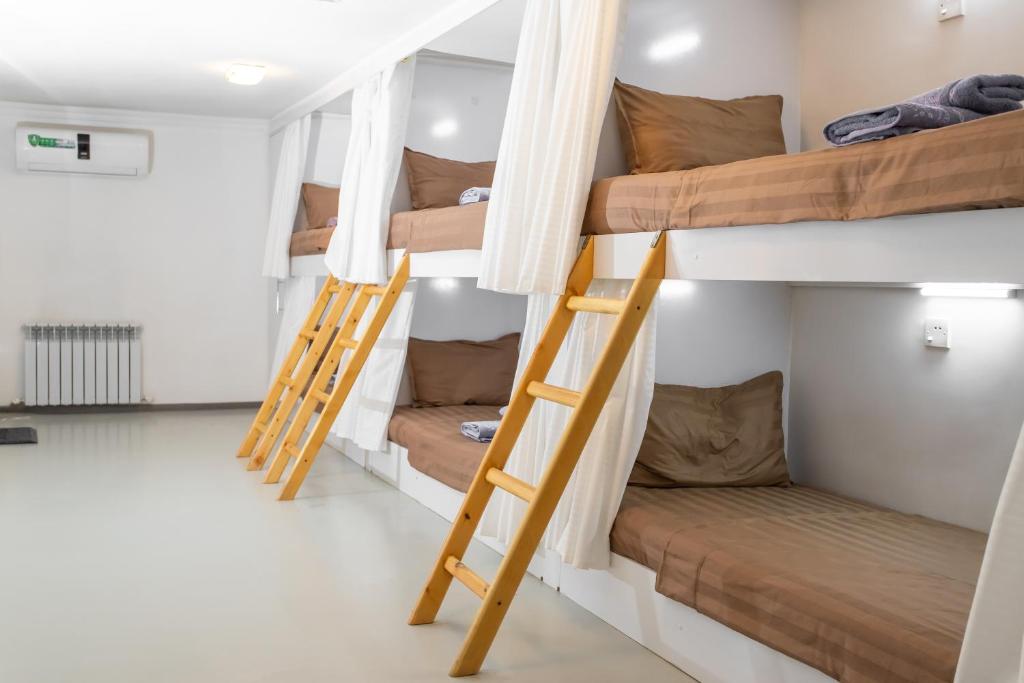 a group of bunk beds in a room at Heartland Hostel Samarkand in Samarkand
