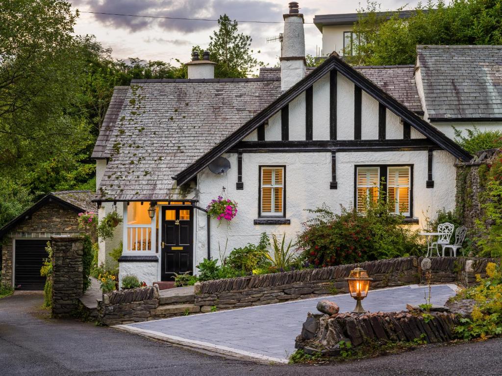 a white house with a black and white roof at Fellside Lodge in Windermere