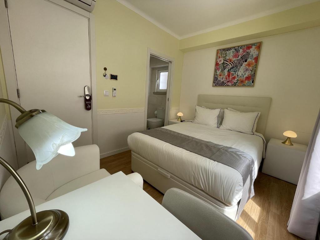 Postel nebo postele na pokoji v ubytování SK Lisboa Villa Guesthouse
