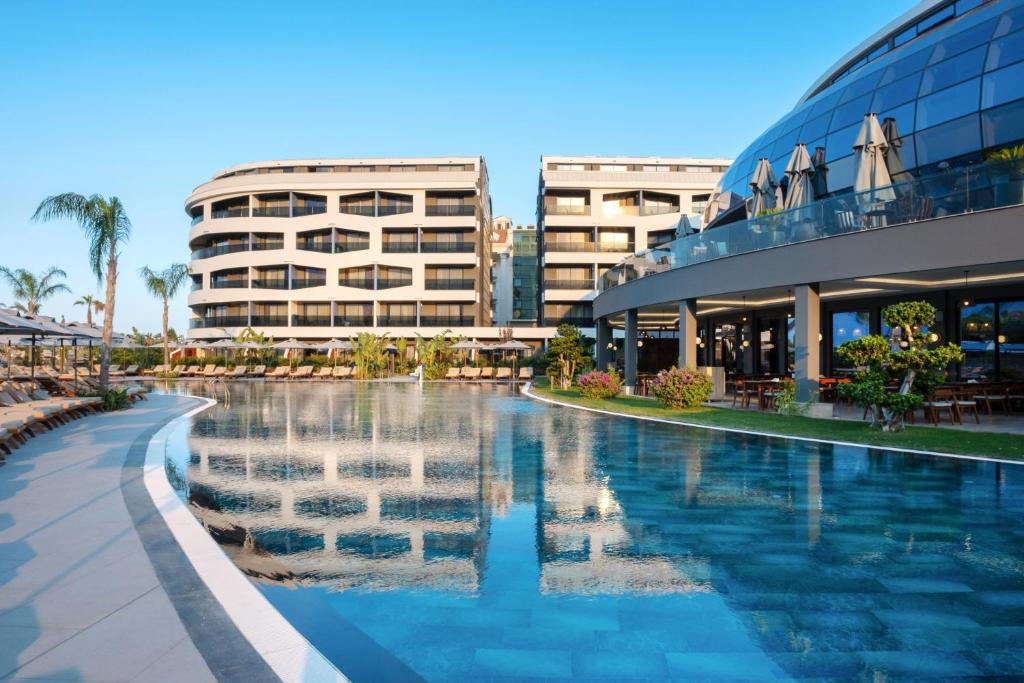 a swimming pool in front of a building at Liu Resorts in Side