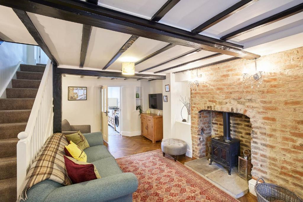 a living room with a couch and a fireplace at Host & Stay - Willow Cottage in Helmsley