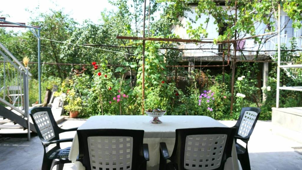 a table and chairs in a garden with flowers at Center in Goris