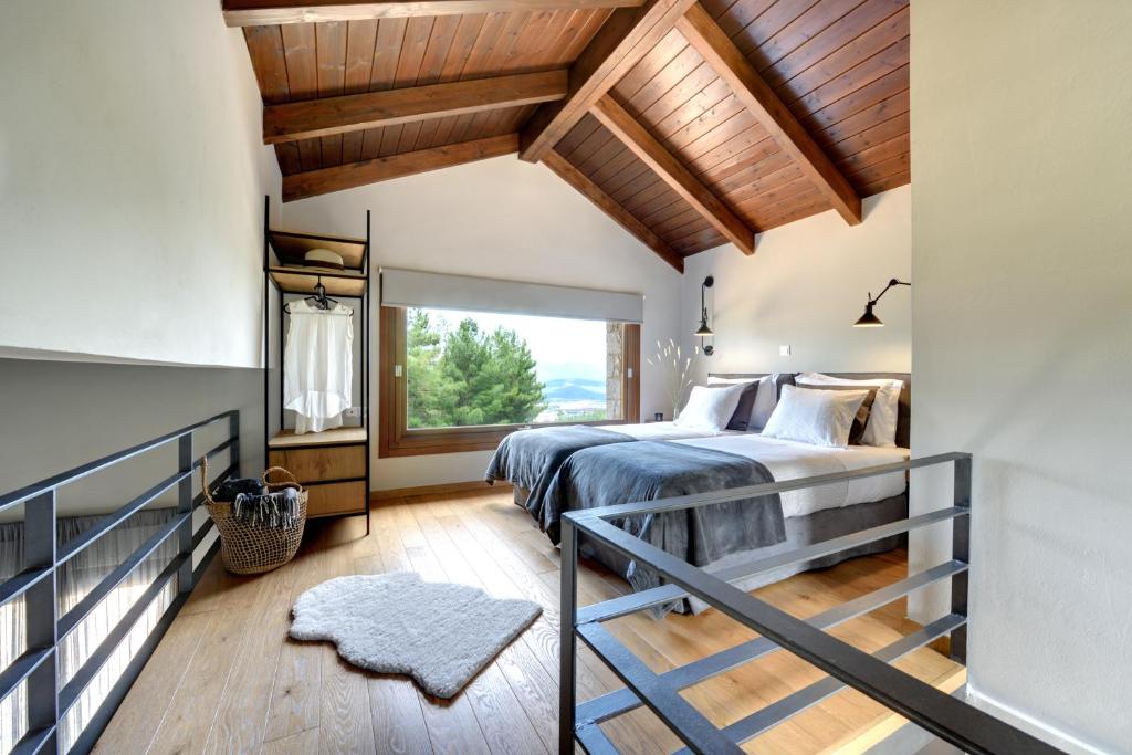a bedroom with a bed and a large window at Amfikleia Chalet in Amfikleia