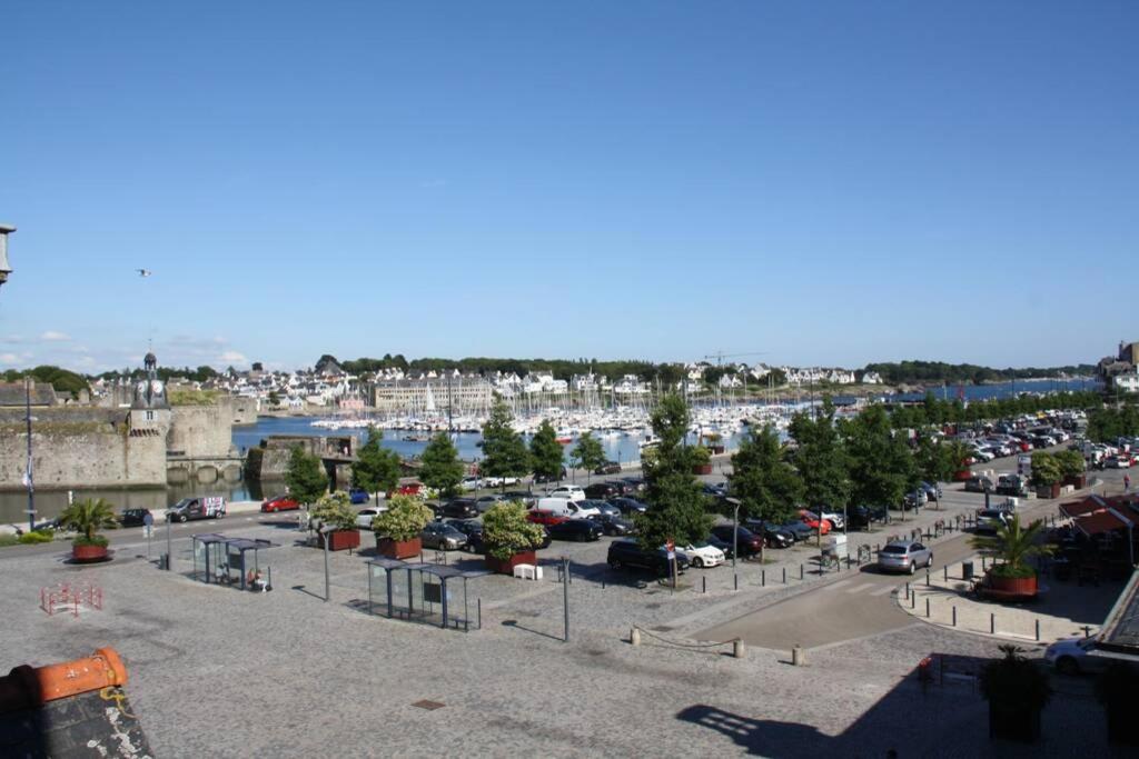 a parking lot with a bunch of cars in a harbor at **La Bretonnerie, bel appartement de standing in Concarneau