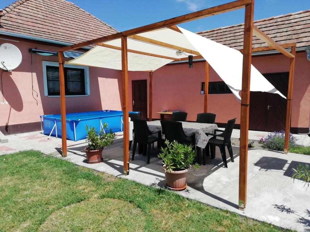 a patio with a table and chairs under a pavilion at Berni Apartman in Balatonkeresztúr