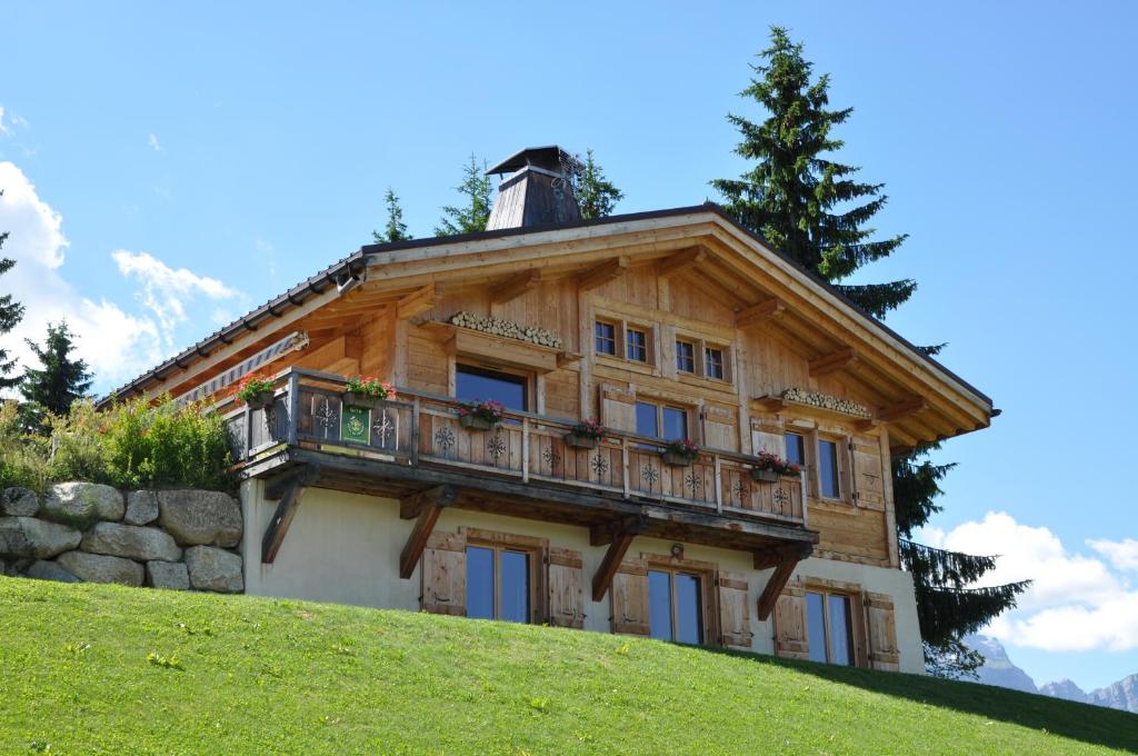 a wooden house on top of a hill at Les Belles Cimes in Combloux