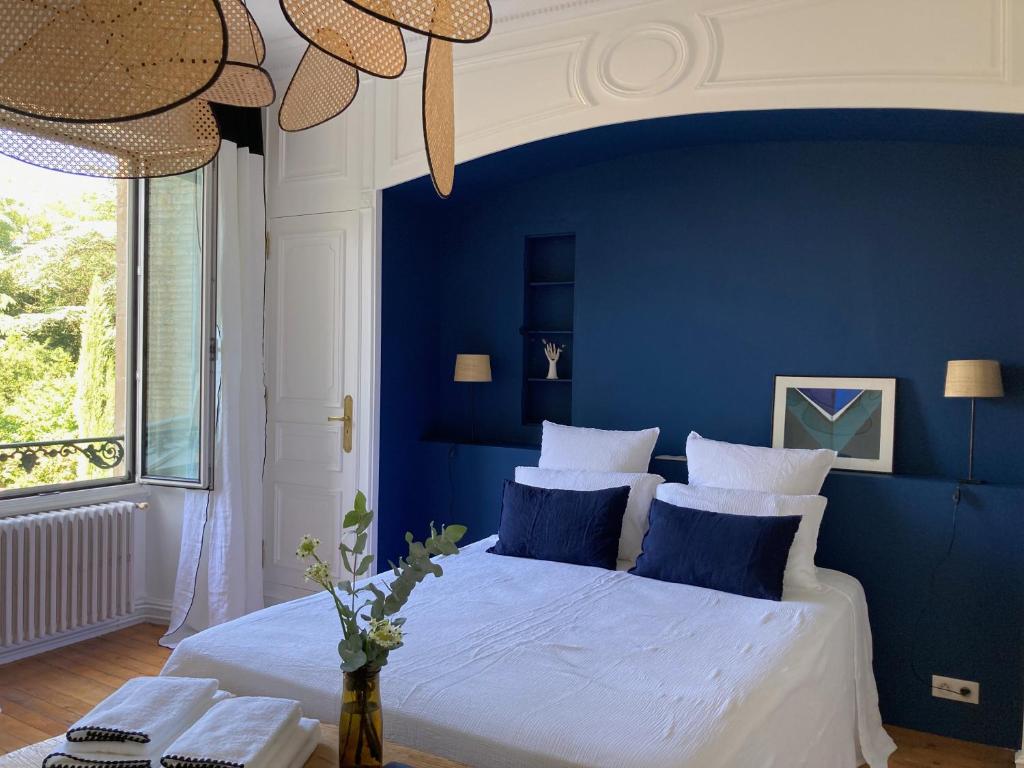a blue bedroom with a large bed with blue walls at Chambres d&#39;hôtes - La Maison 19 in Niort