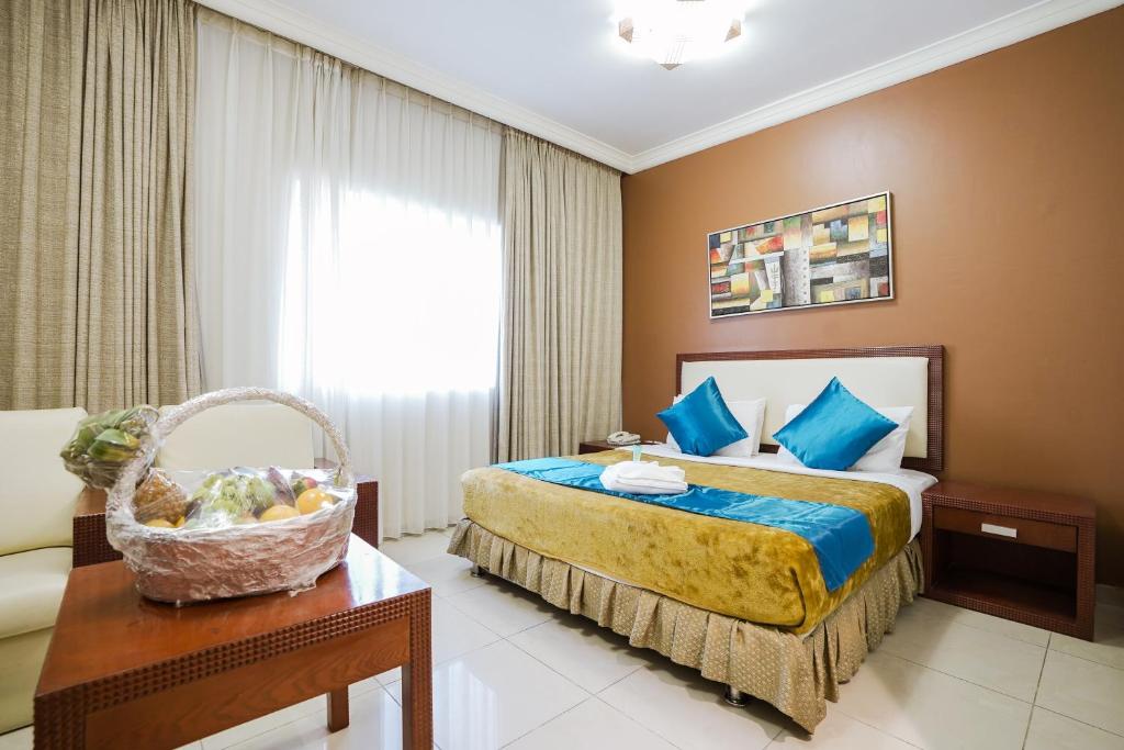 a hotel room with a bed and a basket on a table at Crystal Plaza Hotel in Sharjah