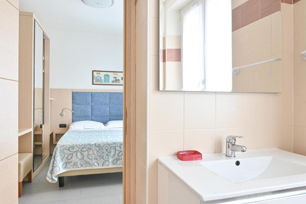 Postel nebo postele na pokoji v ubytování Hotel Marco's