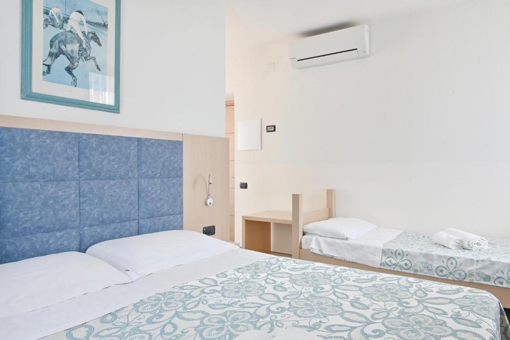 Postel nebo postele na pokoji v ubytování Hotel Marco's