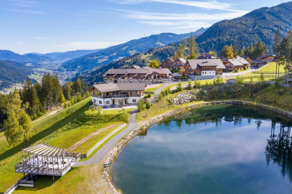 an aerial view of a resort with a lake at Almwelt Austria in Schladming