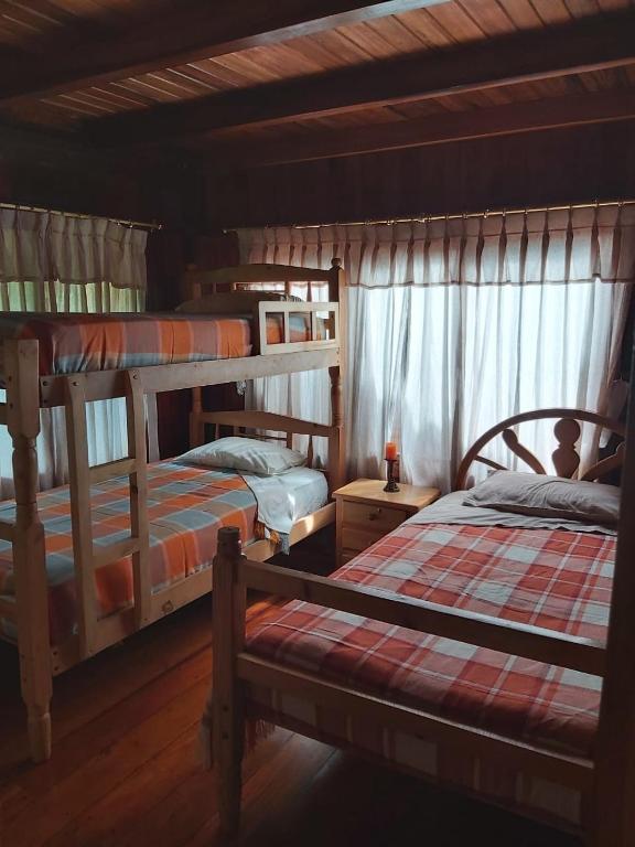 Postel nebo postele na pokoji v ubytování Colinas de Mindo