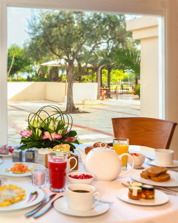a table with breakfast foods and drinks on it at The Residence Tunis in Gammarth