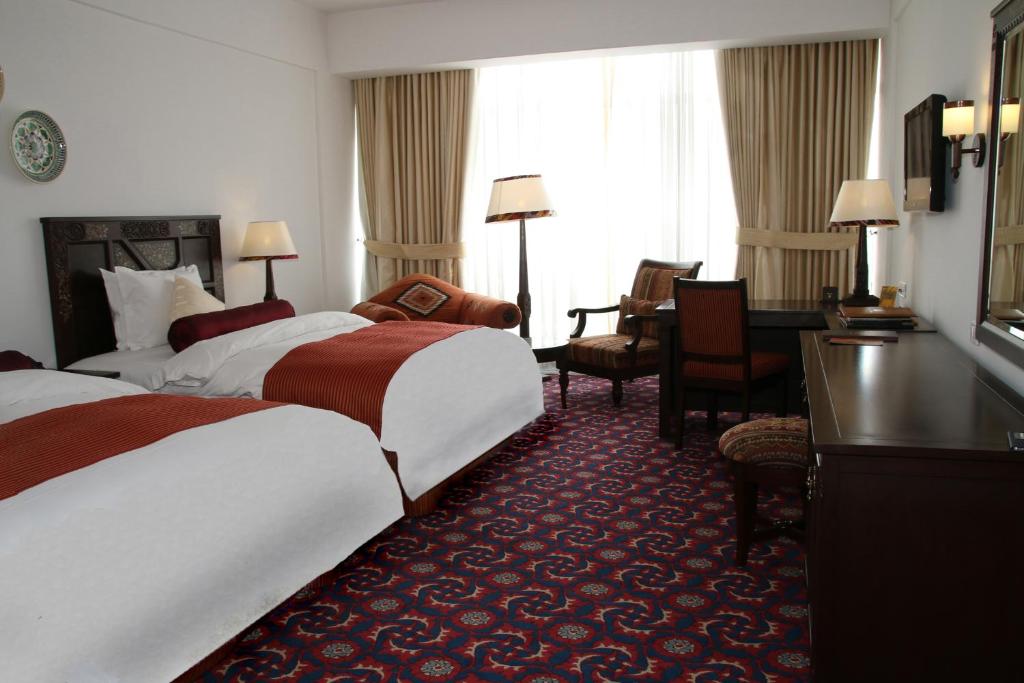 Postel nebo postele na pokoji v ubytování Dushanbe Serena Hotel