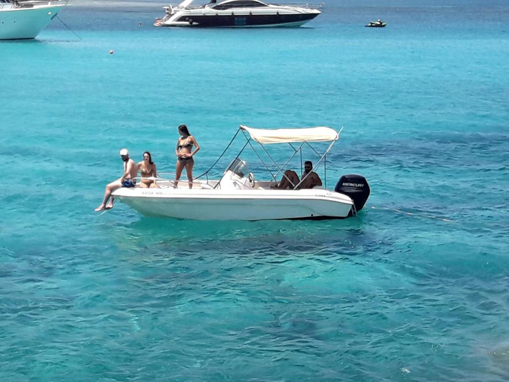 eine Gruppe von Menschen auf einem Boot im Wasser in der Unterkunft SEAFRONT BEACH PARTY VILLA in Perivolia